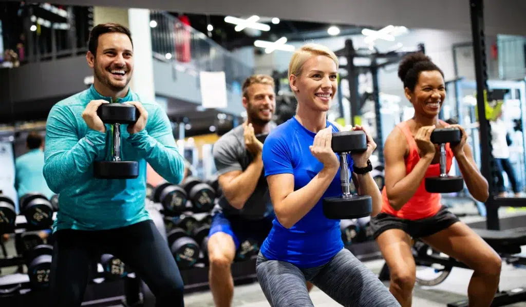 Happy people working out at a gym