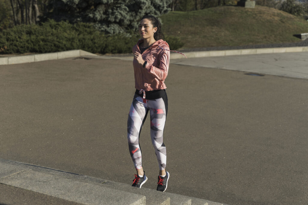 a women running wearing a legin