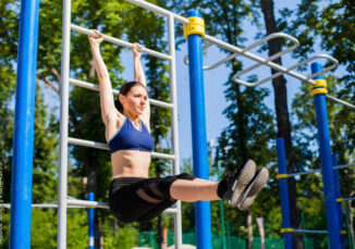 Woman in one of blue seamless sports bras working out at a park.